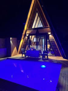 a house with a swimming pool at night at OLİVE GARDEN ANTALYA in Bahtılı
