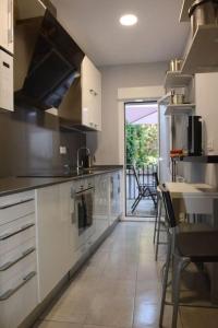 a kitchen with white cabinets and a view of a patio at Casa Macarena Espectacular Plaza Mayor in Ciudad-Rodrigo