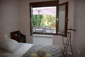 a bedroom with a bed and a large window at Casa Macarena Espectacular Plaza Mayor in Ciudad-Rodrigo