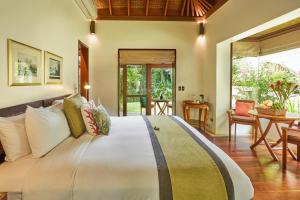 a bedroom with a large bed in a room at The Farm at San Benito in Lipa