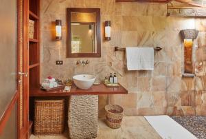 a bathroom with a sink and a mirror at The Farm at San Benito in Lipa