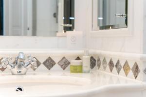 a bathroom with a sink and a mirror at Powerscourt Hotel, Autograph Collection in Enniskerry