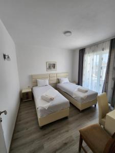 a hotel room with two beds and a window at Apartment FLORA in Bregvija