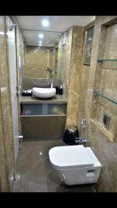 a bathroom with a white toilet and a sink at Bandra’s Prime luxurious 2 BHK in Mumbai