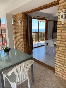 a table and a chair in a room with a balcony at Brisa Marina in Las Canteras