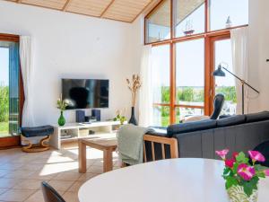 a living room with a couch and a tv at 8 person holiday home in Ulfborg in Thorsminde