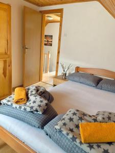 a bedroom with two beds with towels on them at Planinska kuća za odmor Perić in Prozor