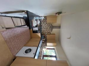 a small room with a staircase with a washing machine at Immaculate 3-Bed House in Middleton in Middleton