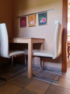 2 sillas y una mesa en una habitación en Lawendowa Galeria MINI, en Brożec