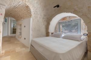 Postel nebo postele na pokoji v ubytování A Piedi Scalzi nel Trullo by Perle di Puglia