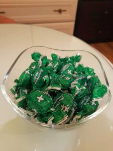 a glass bowl filled with green football treats at Adrys Boutique Villa in Constanţa