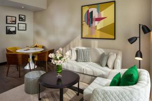 a living room with a couch and a table at SILVER FOX HOMES in Dubai