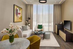 a living room with a couch and a table at SILVER FOX HOMES in Dubai