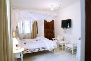 Postel nebo postele na pokoji v ubytování Met Beach Resort Malindi