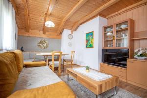 a living room with a couch and a table at Apartments Culac in Santa Cristina Gherdëina