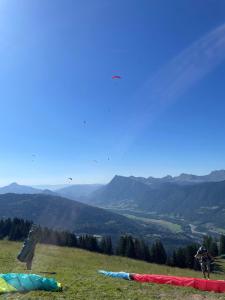a person riding a bike on a hill with tents at Samoëns 1600 studio au pied des pistes in Samoëns +4 photos