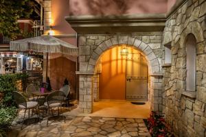 an entrance to a building with a stone wall at PargaMondo Countryliving in Parga