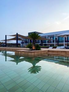 a swimming pool in front of a building at Silken Platja d'Aro in Platja  d'Aro