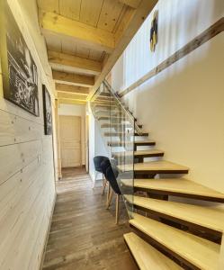 a staircase in a room with wooden floors and wooden ceilings at Chalet L'Albaron in La Toussuire