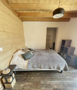 a bedroom with a bed and a wooden wall at Chalet L'Albaron in La Toussuire