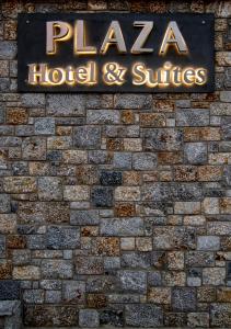 a hotel sign on the side of a brick wall at Plaza Hotel in Masouri