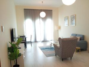 a living room with a couch and a table at Vibrant,affordable Apt 5 Minutes From Metro in Dubai