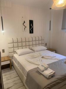 a bedroom with two beds with towels on them at Litsa Apartments in Fourka