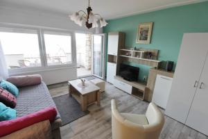 a living room with a couch and a table at Apartment Zeljka in Crveni Vrh