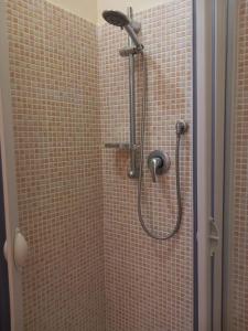 a shower with a shower head in a bathroom at La Suite dei Ricami in Agrigento