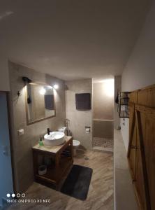 a bathroom with a sink and a toilet and a mirror at Neoclassical Samos House Nafsika in Samos