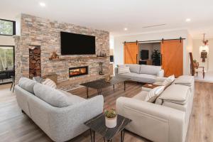 a living room with two couches and a fireplace at Raffaele's Estate - Margaret River in Wilyabrup