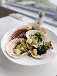 a plate of food with oysters on a table at Housel Bay Hotel in Lizard