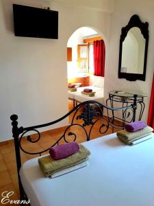 A bed or beds in a room at EVANS Skiathos