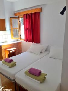 A bed or beds in a room at EVANS Skiathos