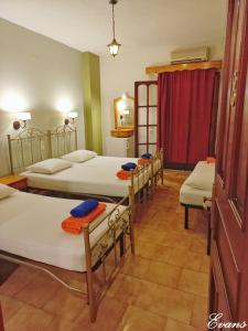 A bed or beds in a room at EVANS Skiathos