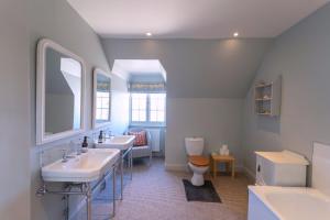 a bathroom with two sinks and a toilet at Butley Priory Farmhouse 12 in Woodbridge