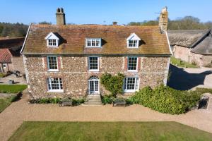 an aerial view of a large brick house at Butley Priory Farmhouse 12 in Woodbridge