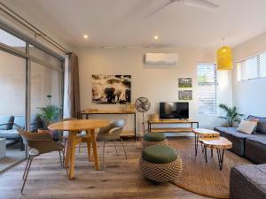 - un salon avec un canapé et une table dans l'établissement Miombo Mews, à Victoria Falls