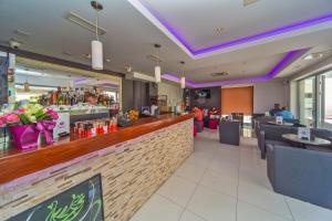 a restaurant with a bar with purple lighting at Dubrovnik Luxury Residence – L’Orangerie in Dubrovnik