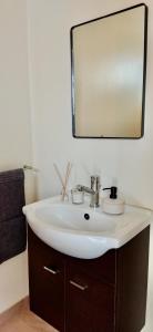 a bathroom with a sink and a mirror at APARTAMENTO DO LAGAR in Algoz