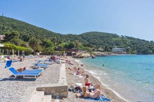 a group of people laying on a beach at Dubrovnik Luxury Residence – L’Orangerie in Dubrovnik