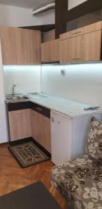 a kitchen with a counter and a sink and a couch at Primorsko Apartments in Primorsko