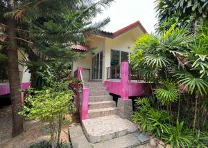 a pink house with some stairs in front of it at Mae Somboon House in Lamai