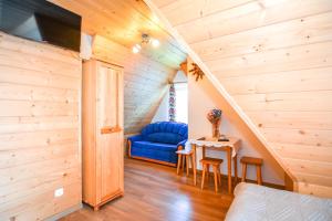 a room with a blue couch and a table at Willa Góralska in Biały Dunajec