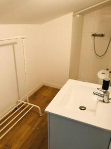 a white bathroom with a sink and a toilet at La Maison Racine 2 - Joli duplex sous les toits in Avignon