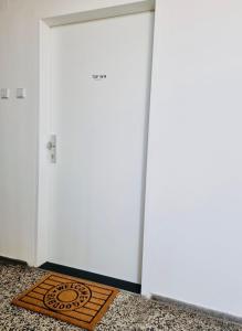 a door with a mat in front of it at BaMo Studio - city living downtown in Klagenfurt