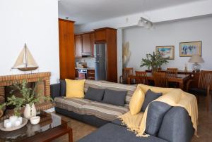 salon z kanapą i kuchnią w obiekcie My Porto Villa w mieście Porto Rafti