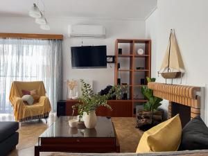 a living room with a couch and a table at My Porto Villa in Porto Rafti
