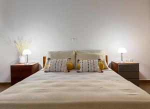 a bedroom with a large bed with two night stands at My Porto Villa in Porto Rafti