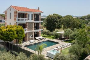 a villa with a swimming pool and a house at Sun Dream Villa in Ialyssos